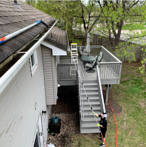 Exterior home cleaning with water-fed pole
